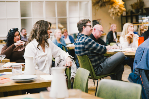 Group of people sat at tables